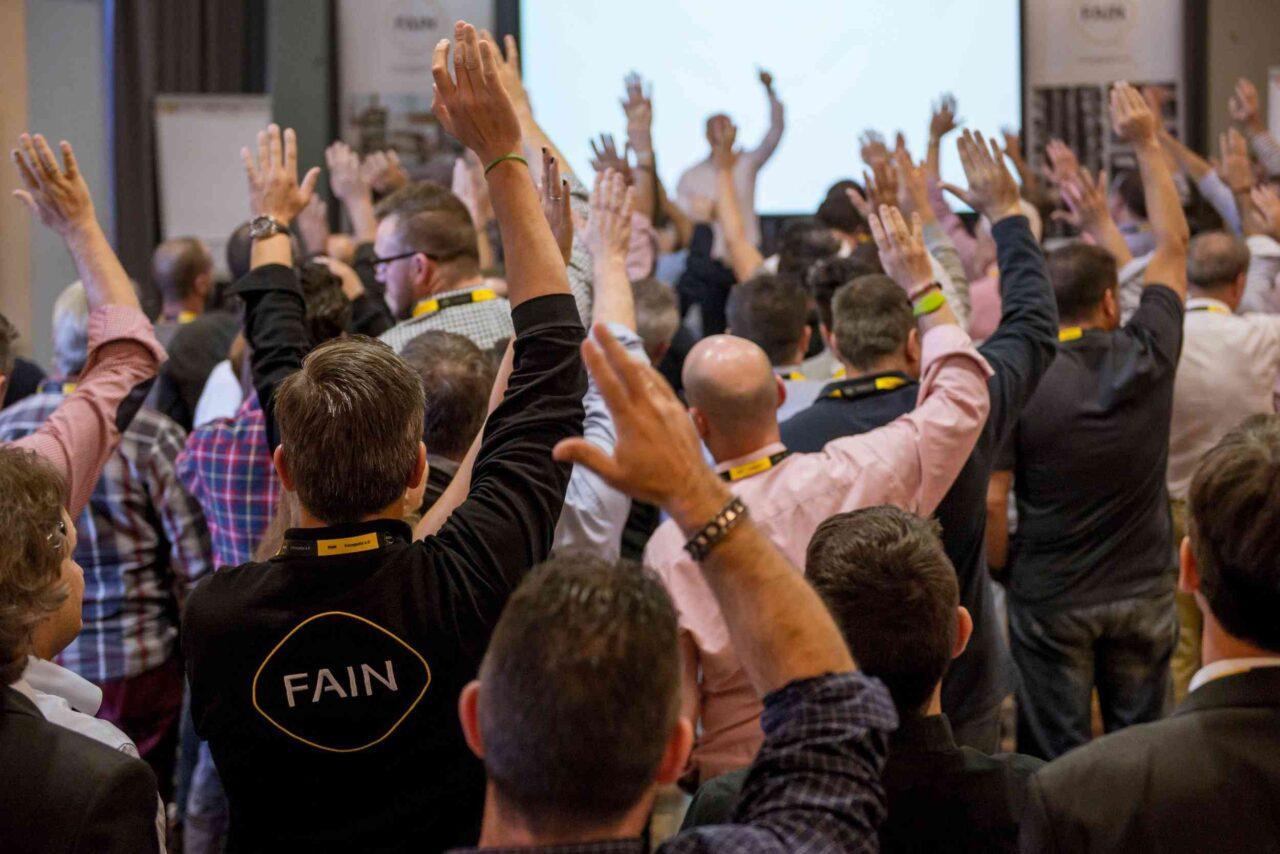 FAIN workers raising their hands at the EuroForum 2017