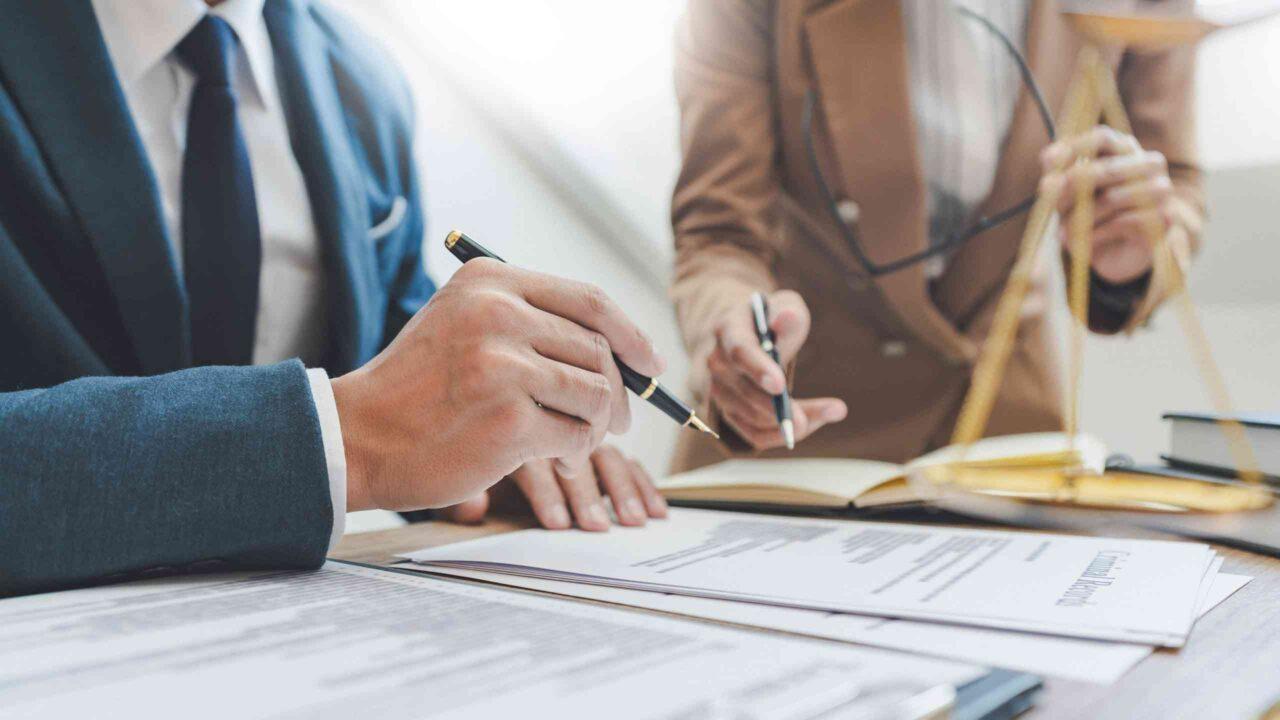 Two people signing a document