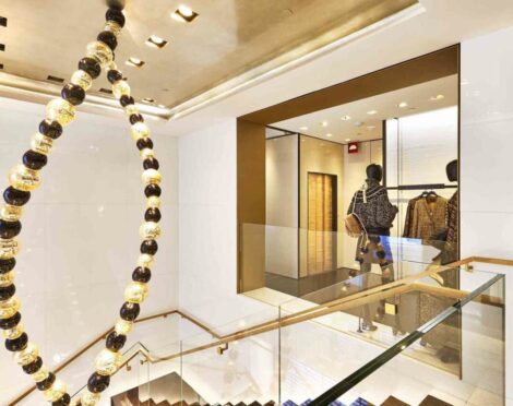 Stylish retail interior with mannequins and a decorative staircase.