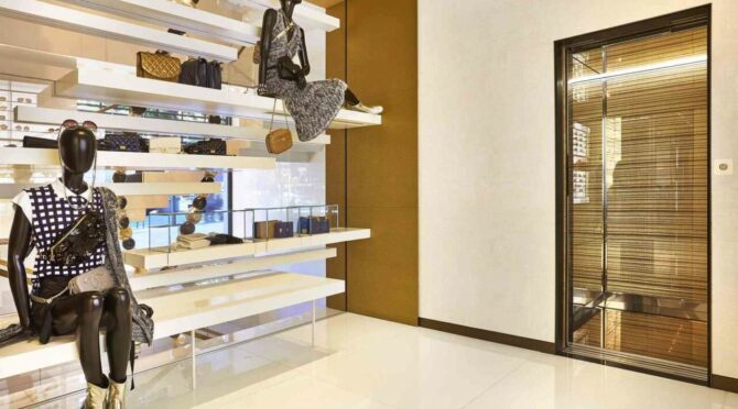 Luxury retail store interior with mannequins and accessories.