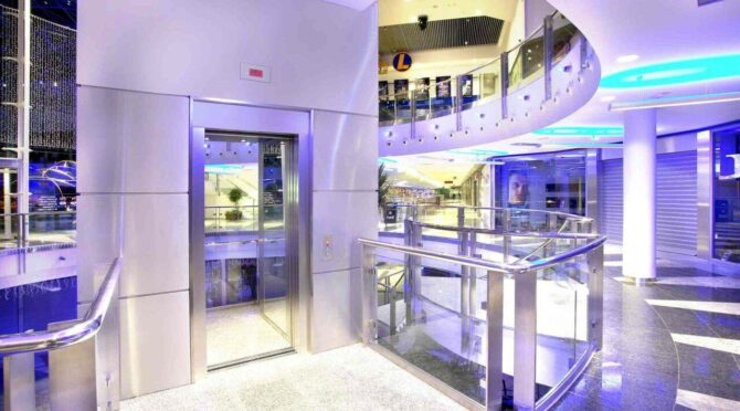 Interior of a modern building with an open elevator and sleek design.