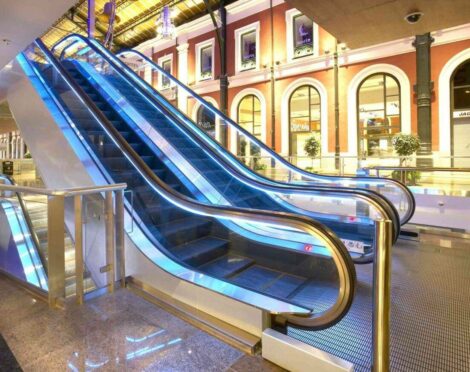 Modern indoor setting with blue-lit escalators.